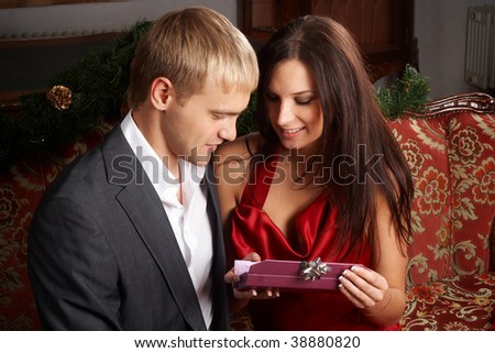 Young man presenting expensive gift to his girlfriend