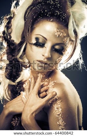 Vogue style portrait of a woman with goldsilver bodyart and makeup