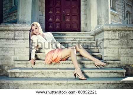 Beautiful young lady in long dress at old manor