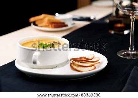 Puree of squash soup with smoked cheese and croutons