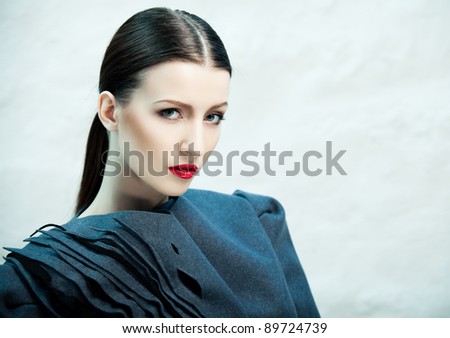 Fashion portrait of beautiful female model covered with blue light