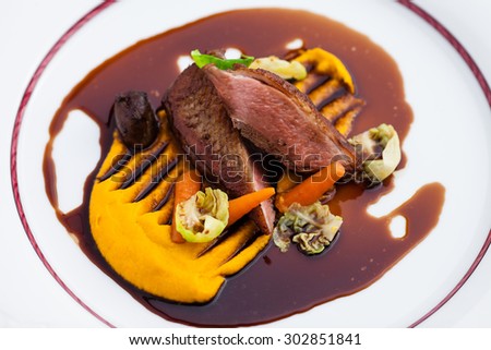 Roasted duck fillet with carrot-orange puree, slow-cooked duck heart and prune sauce