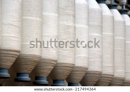 Rolls of spun cotton in a textile factory