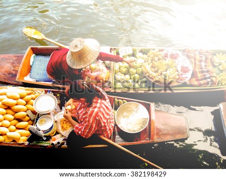 Floating market in Thailand in vintage photo style with intentional sun glow effect applied