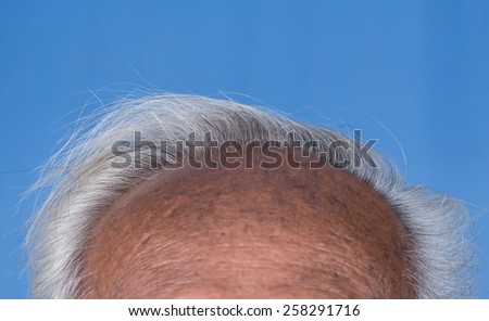 Close up of grey hair on top of elderly man head, wrinkle, tan skin