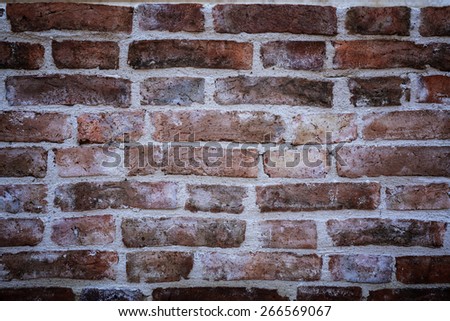 ancient old red brick wall fragment with vignetted corners background, texture.