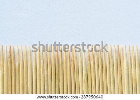 Toothpick on rough gray background.
