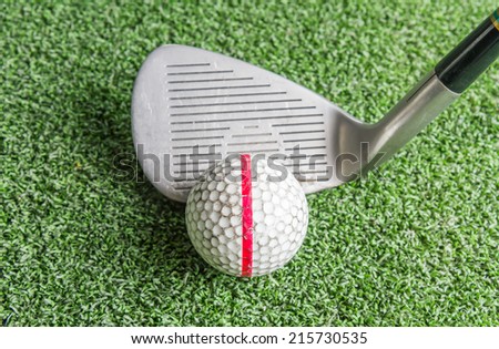 Close up, Old golf balls and iron on artificial grass in driving range for practice.