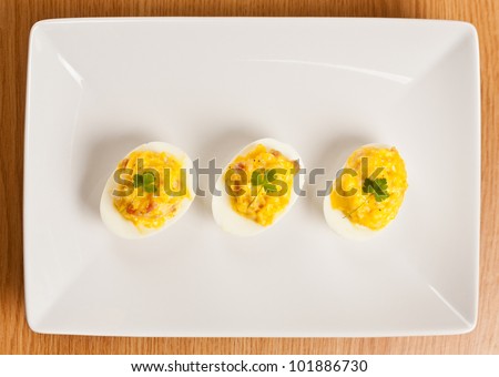 Stuffed eggs on plate, shot from above
