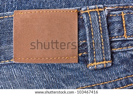 Blank grunge leather label sewed on a blue jeans.