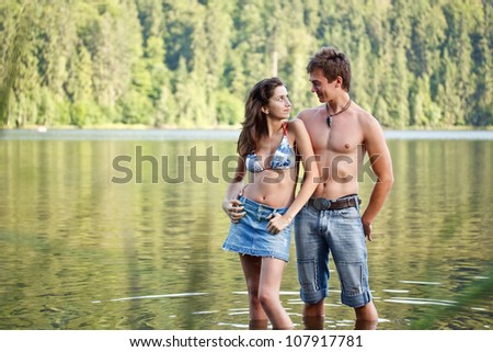 Young couple in lake water lost in love