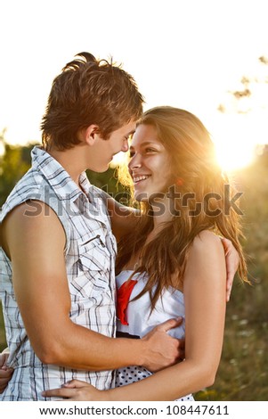 Young couple lost in love outdoor during the sunset