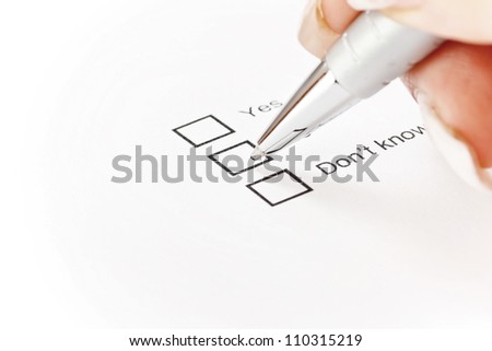 Hand on pen choosing one of three options