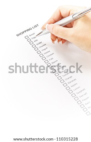 Woman hand checking a shopping list