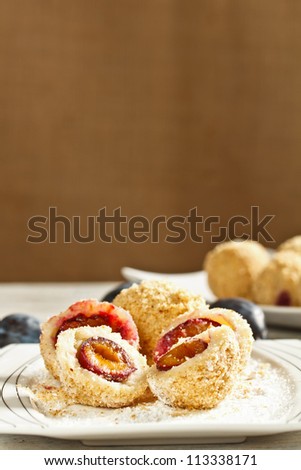Plum dumplings coverder with breadcrumb and sprinkled with sugar