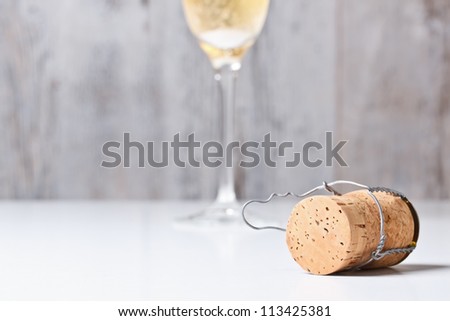 Champagne glass and cork on table