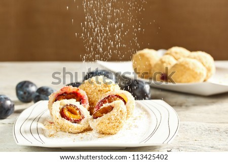 Plum dumplings with buttered breadcrumbs and sugar