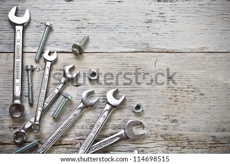 Stainless steel wrench set on wood background