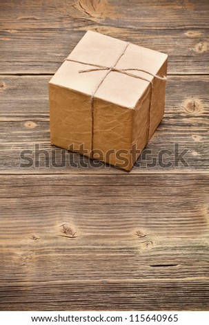 Wrapped packaged box on wood background