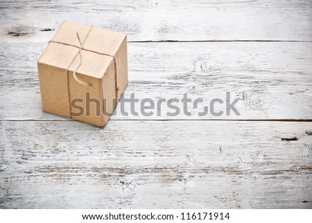 Wrapped packaged box on wood background