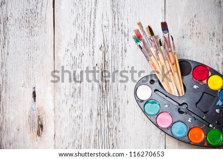 Watercolor paints set with brushes after using
