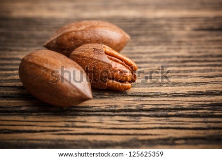 Pecan nuts on old wooden background