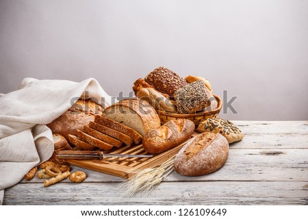Mix of bread on cutting board and on basket