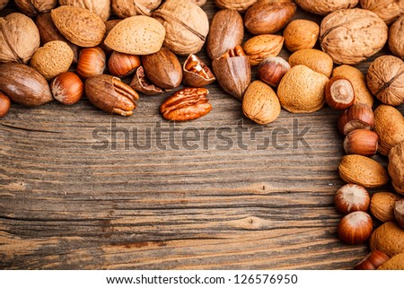 Assortment of hard shell nuts on wooden background