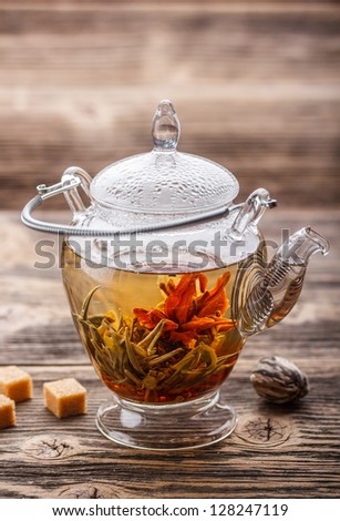 Exotic blooming tea in glass teapot