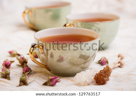 Cup of tea with rose bud and rock sugar sticks