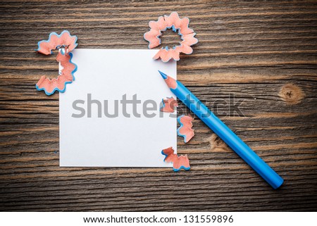 Sharpened blue color pencil with paper and wood shavings