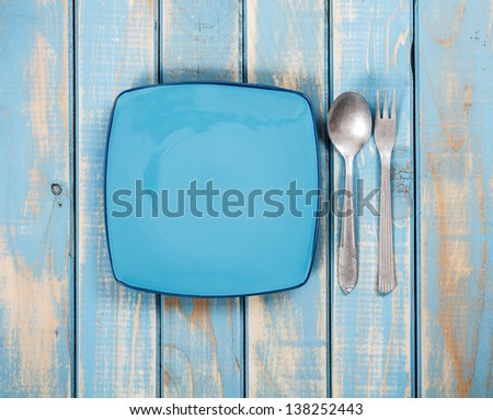 Dinner set on painted blue wooden background