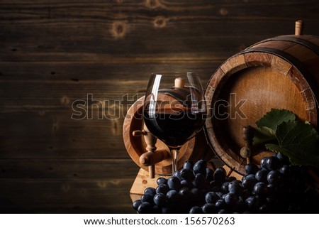 Wine concept with glass, grape fruit and barrel