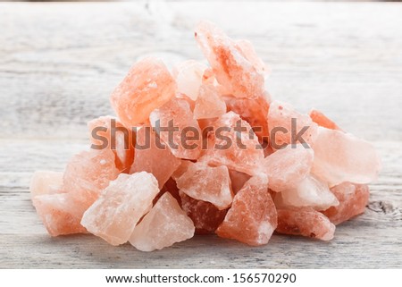 Himalayan crystal salt on wooden background