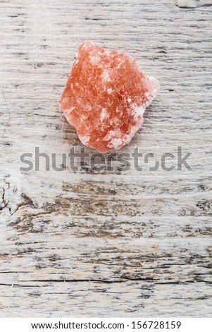 Himalayan pink crystal salt on wooden background
