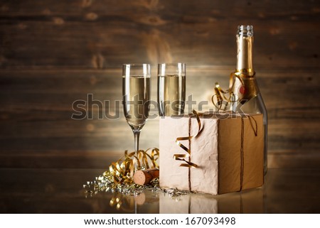 New Year concept with champagne and rustic gift box