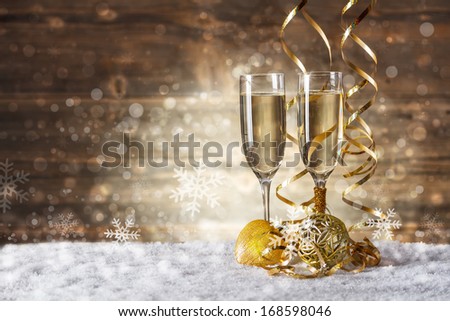 Gold Christmas balls with glass of fizz
