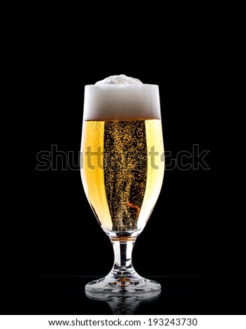 Glass of beer on a black background