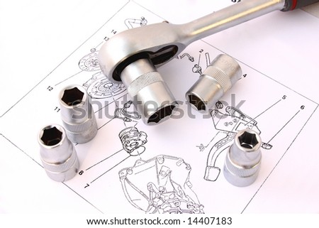 ratchet spanner and sockets on technical draw background