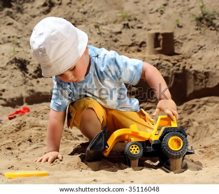 Little child play with sand