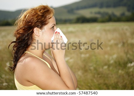 brunette woman having a pollen allergy in the nature