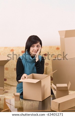 Attractive woman with box making a removal