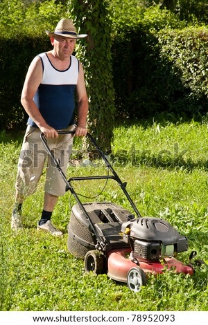 Senior man mowing the lawn