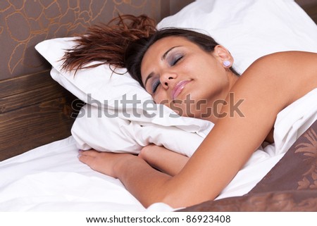 Beautiful woman is peacefully sleeping in her bed