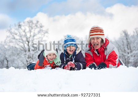Family laying down in the snow