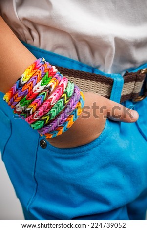 Boy wearing colorful loom band rubber bracelets