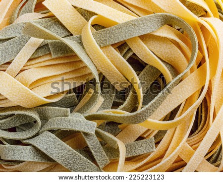 Close up of yellow and green uncooked pasta tagliatelle