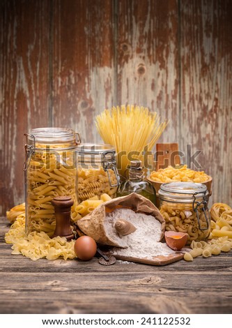 Still life of italian pasta on rustic wooden board