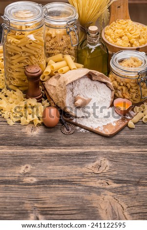 Various raw pasta in a glass jar whit pasta ingredients