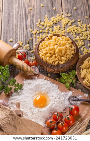 Still life with raw pasta and ingredients for pasta